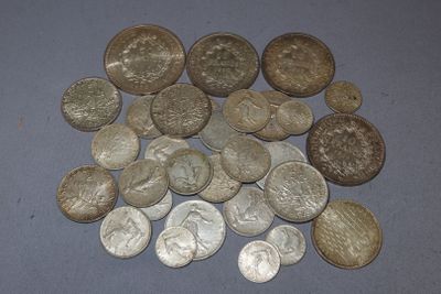 a pile of silver coins on a blue surface