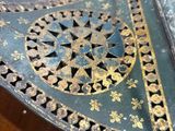 a metal object that is sitting on a wooden table