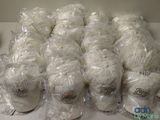 many balls of yarn wrapped in plastic bags on a table