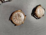two watches that are sitting on a table