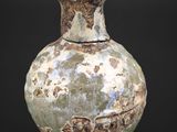a vase that is sitting on a black surface