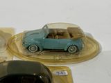 two toy cars sitting on top of a table next to a mouse