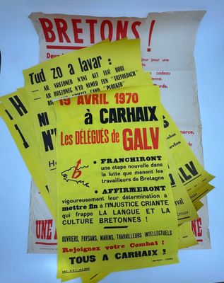 several yellow and black concert posters on a white surface