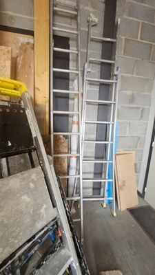 a ladder that is leaning against a wall in a room