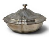 an antique silver plate covered dish with a lid on a white background