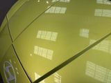 a close up view of a yellow car with windows