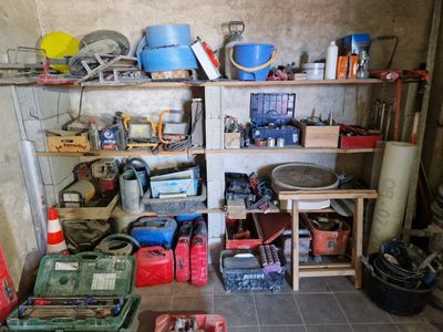 une pièce remplie d'outils en tout genre, rangés sur des étagères