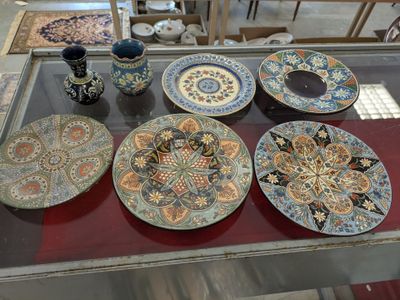a lot of plates and cups on a glass table