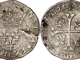 a silver coin with a cross on the front and a cross on the back