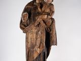 an old wooden statue of a woman holding a child