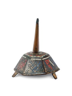 an old wooden incense holder with a wooden stick sticking out of it
