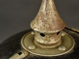 a close up of a black and gold helmet with a pointed top