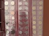 a lot of coins in a red case on a table