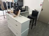 a white dresser with clothes on it in a room