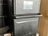 a black refrigerator sitting on top of a kitchen counter