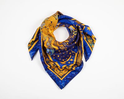 a blue and yellow square scarf with a gold dragon on it