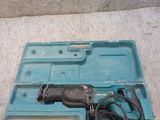 a drill in a blue case on the floor