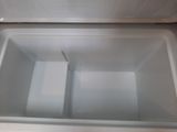 underside view of a white refrigerator with the door open