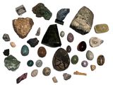 various types of rocks and stones arranged in a circle on a white surface