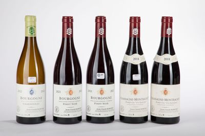 six bottles of wine are lined up on a white surface