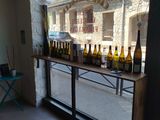many bottles of wine sitting on a table in front of a window