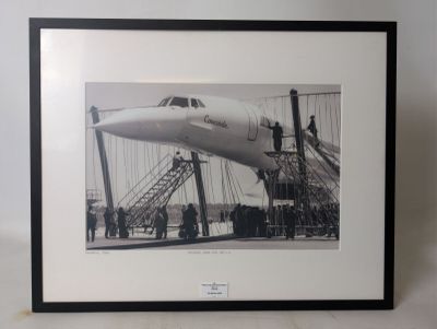 black and white photograph of a plane being loaded with passengers