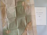 a map on a table with a piece of paper next to it
