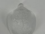 a glass object on a white surface with a white background