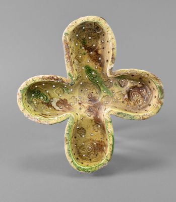 an image of a ceramic cross on a gray background