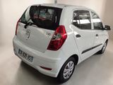 a small white car that is parked in a garage