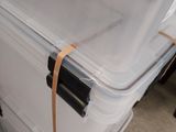a white suitcase with a handle on it sitting on the floor