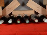 several bottles of wine are lined up in a row on a table