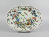 a close up of a plate with flowers and birds on it