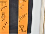 a picture of a framed picture with many autographs on it