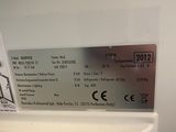 a picture of a ticket sitting on top of a refrigerator
