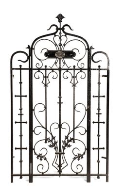 a black iron gate with a clock on top of it