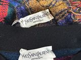 three sweaters with labels on them sitting on top of each other