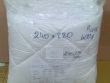 a pillow that is wrapped in plastic on the floor