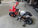 a small child ' s motorcycle that is sitting in the garage
