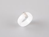 a close up of a white ring with a diamond on it