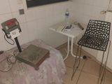 a room with a bed, a table, and a chair in it