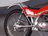 a red motorcycle that is parked in a parking lot