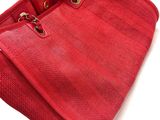 an image of a red purse on a white surface