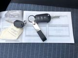 a car key, a car keychain, and a car key on a piece of paper