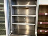 an empty refrigerator in the middle of a store