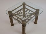 a glass table with metal legs and a glass top
