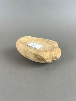 un gros plan d'une pierre posée sur une table, sur laquelle est accrochée une étiquette