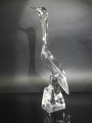 an image of a glass bird sitting on top of a glass block
