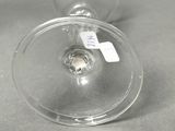 a wine glass with a label on it sitting on a table