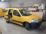 a yellow van with its door open in a garage